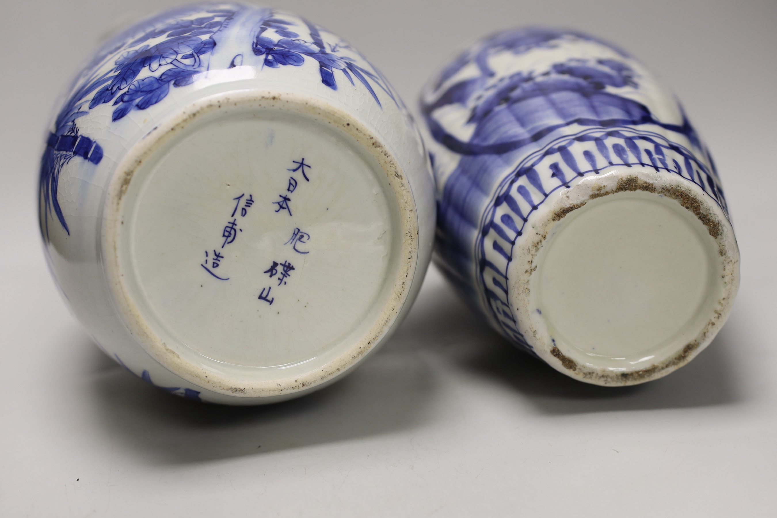 A pair of Japanese blue and white birds and flowers pattern vases and two other vases, tallest 39cm high